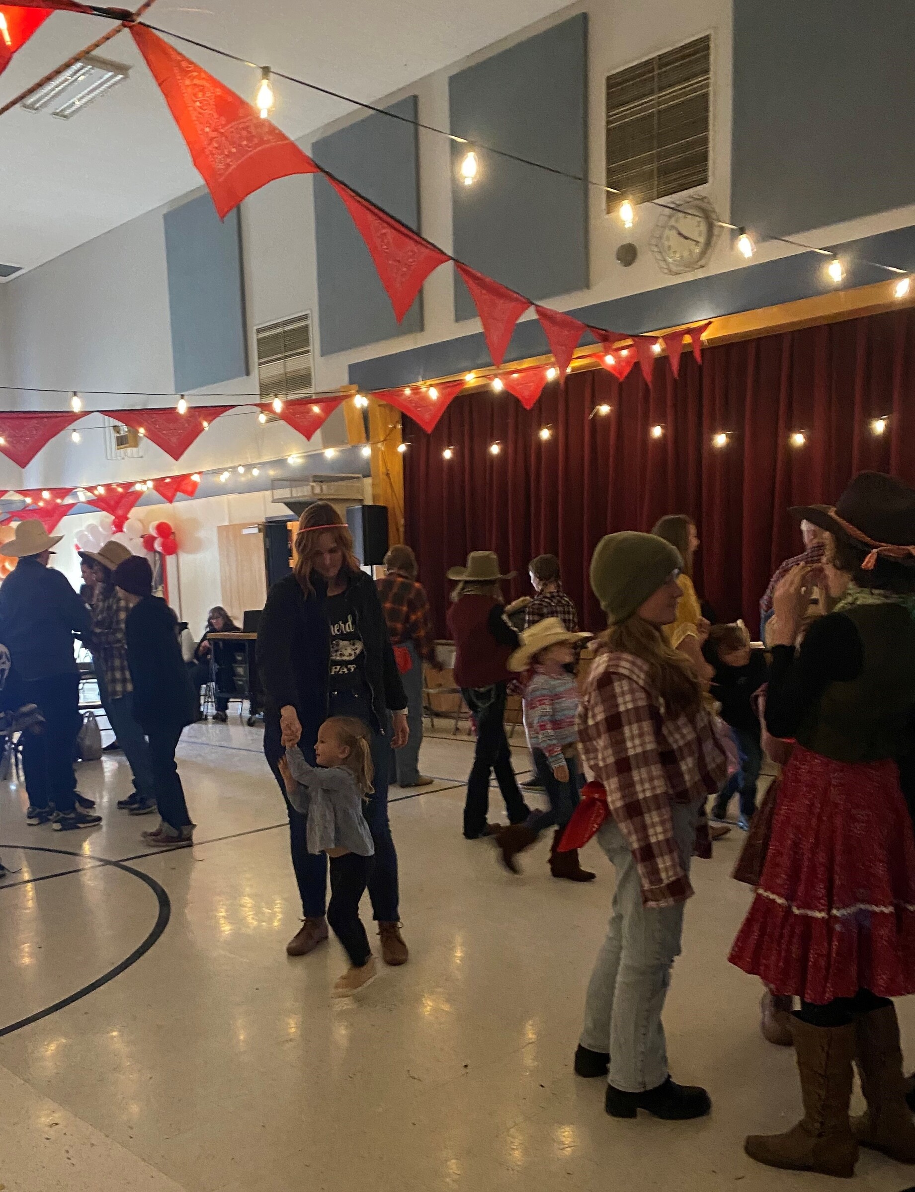 parent dancing with young child in multi-purpose room